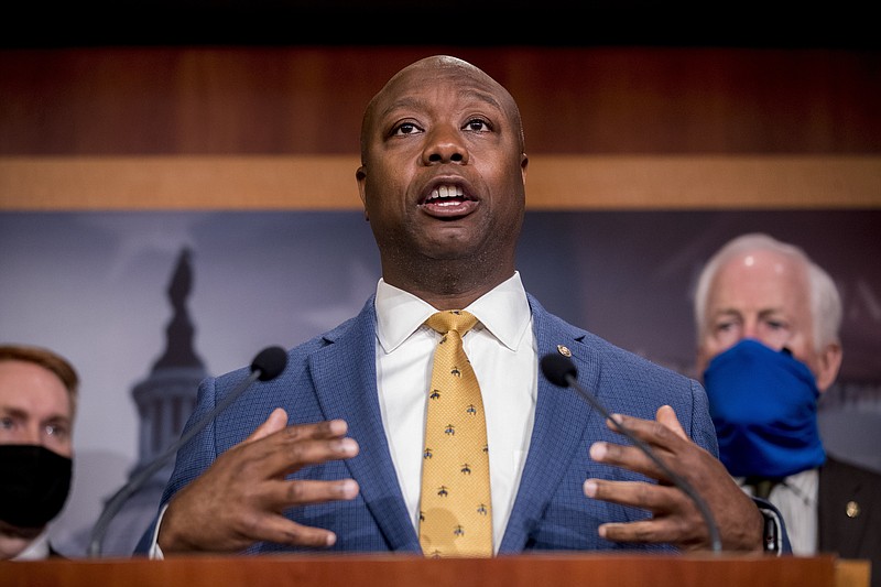 FILE - In this June 17, 2020, file photo, Sen. Tim Scott, R-S.C., accompanied by Republican senators speaks at a news conference to announce a Republican police reform bill on Capitol Hill in Washington. Initially reluctant to speak on race, Scott is now among the Republican Party's most prominent voices teaching his colleagues what it's like to be a Black man in America. (AP Photo/Andrew Harnik, File)


