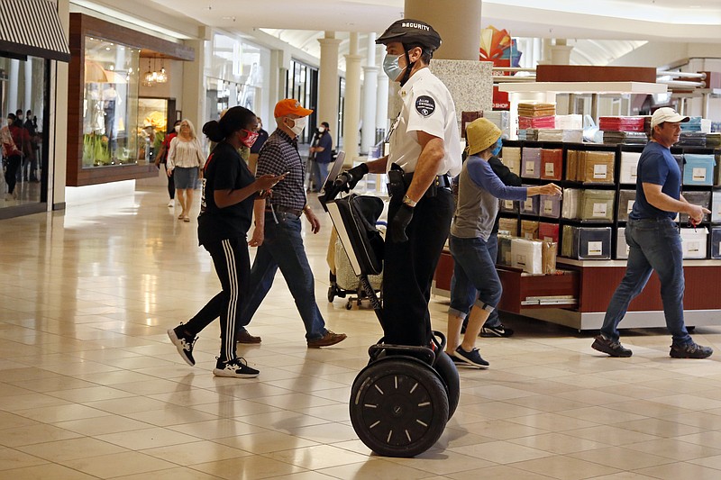 FILE - In this May 1, 2020 file photo, a security guard wearing a mask and riding a Segway patrols inside Penn Square Mall as the mall reopens in Oklahoma City. Segway says it will end production of its namesake two-wheeled balancing personal transporter, popular with tourists and police officers but perhaps best known for its high-profile crashes. The company, founded in 1999 by inventor Dean Kamen, will retire the Segway PT on July 15. (AP Photo/Sue Ogrocki, File


