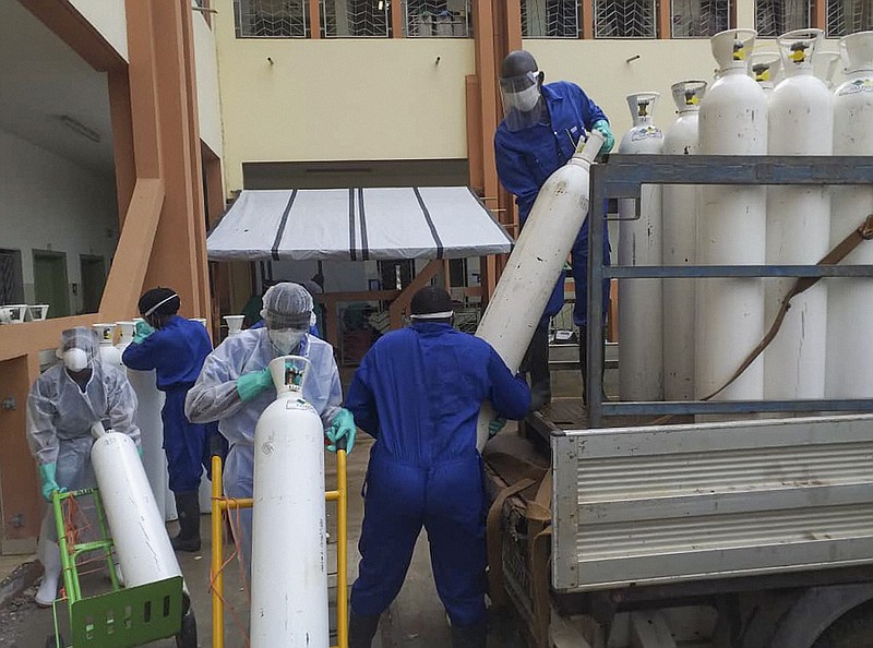 Medical workers offload cylinders of oxygen at the Donka public hospital where coronavirus patients are treated in Conakry, Guinea, on Wednesday, May 20, 2020. Before the coronavirus crisis,the hospital in the capital was going through20 oxygen cylinders a day. By May, the hospital was at 40 a day and rising, according to Dr.BillySivaheraofthe aid group Alliance for International Medical Action. Oxygenis the the facility's fastest-growingexpense, and the daily deliveries of cylinders are taking their toll on budgets. (AP Photo/Youssouf Bah)