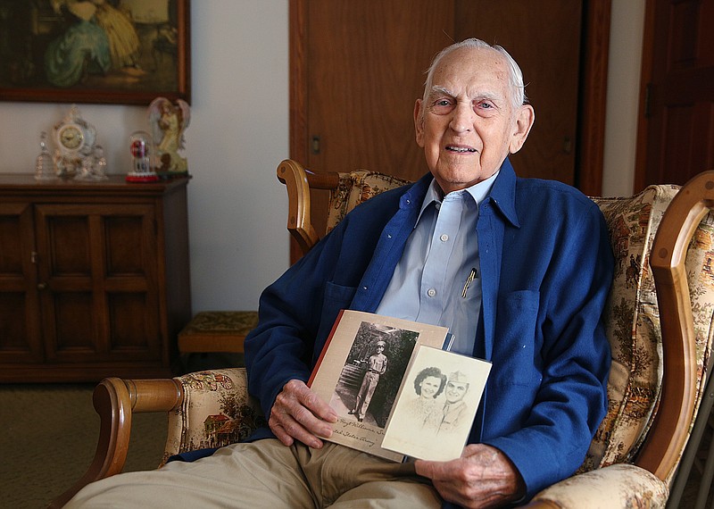 Staff photo by Erin O. Smith / Hoyt Williams Sr. poses for a portrait while holding a photo of himself and a photo of his wife and himself Tuesday, Oct. 31, 2017 at his home in Trion, Ga. Williams served in the Army for about three years, beginning in February 1943.