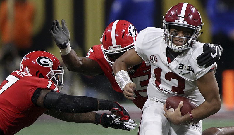 Staff photo by C.B. Schmelter / Alabama quarterback Tua Tagovailoa evades Georgia linebackers Davin Bellamy, left, and D'Andre Walker as he scrambles for a 9-yard gain during the championship game of the 2017 college football season. The matchup at Atlanta's Mercedes Benz-Stadium kicked off on Monday, Jan. 8, 2018, but it didn't finish until after midnight.