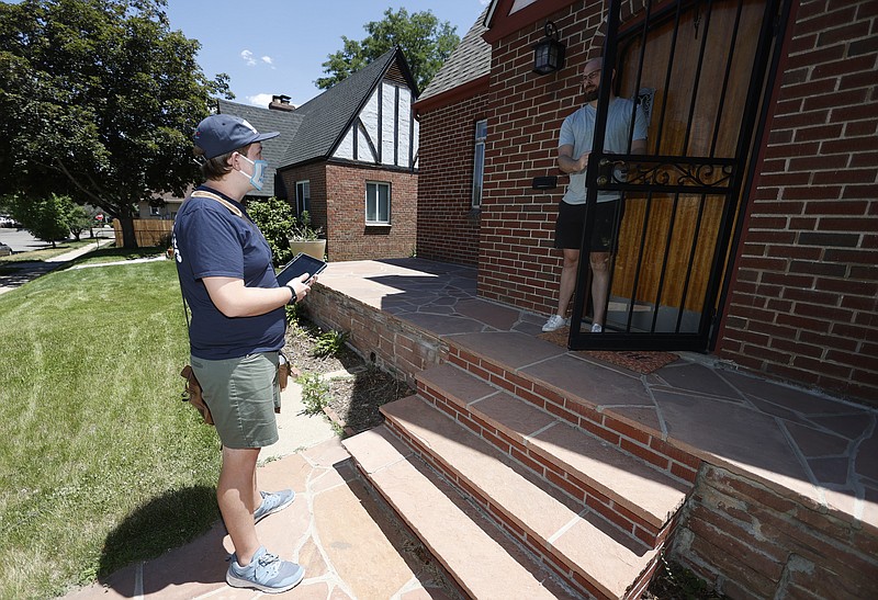 In this Wednesday, June 24, 2020, photo, Joey Prestley, a staff canvasser for the Progressive Turnout Project, left, talks to Scott Gifford while reaching out to voters in the age of the new coronavirus in northwest Denver. The coronavirus pandemic isn't going away anytime soon, but campaigns are still forging ahead with in-person organizing. (AP Photo/David Zalubowski)


