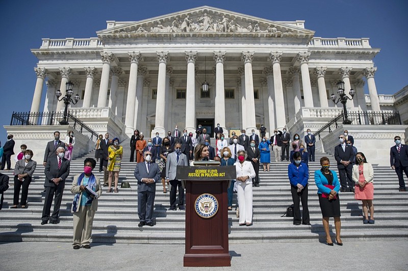 House Speaker Nancy Pelosi of Calif., joined by House Democrats spaced for social distancing, speaks during a news conference on the House East Front Steps on Capitol Hill in Washington, Thursday, June 25, 2020, ahead of the House vote on the George Floyd Justice in Policing Act of 2020. (AP Photo/Carolyn Kaster)


