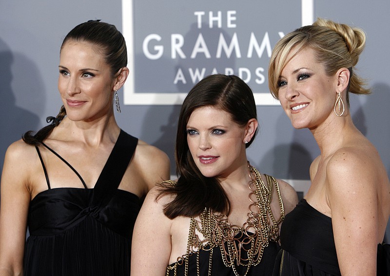 FILE - In this Feb. 11, 2007 file photo, the Dixie Chicks, Emily Robison, left, Natalie Maines, center, and Martie Maguire arrive for the 49th Annual Grammy Awards in Los Angeles. The Grammy-winning country group have dropped the word dixie from their name and are now going by The Chicks. The move follows a decision by country group Lady Antebellum to change to Lady A after acknowledging the word's association to slavery. (AP Photo/Matt Sayles, File)