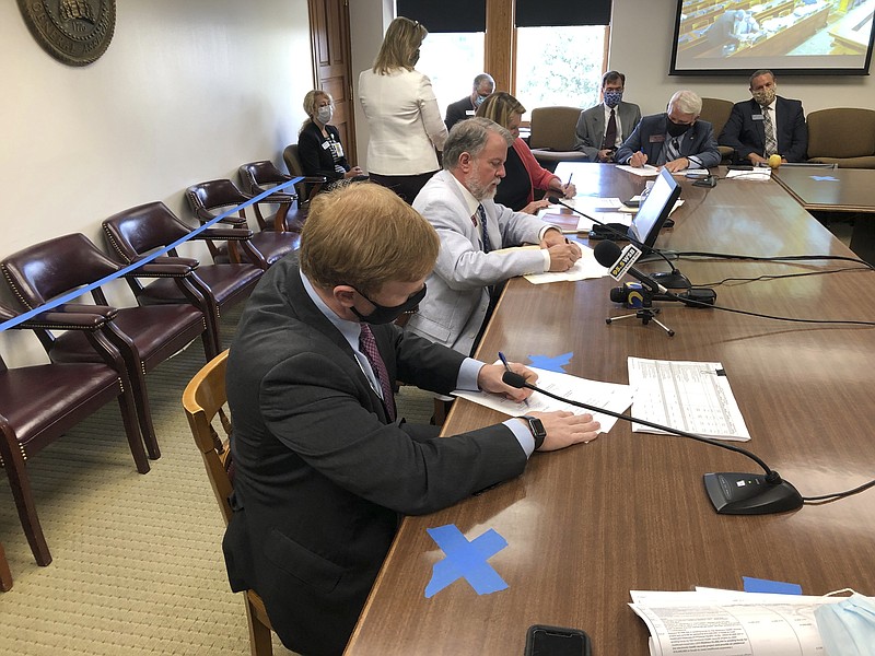 Senate Appropriations Committee Chairman Blake Tillery, left, and House Appropriations Committee Chairman Terry England sign a final agreement on Georgia's state budget on Thursday, June 25, 2020. England and Tillery say they tried to avoid budget cuts that would most directly harm citizens even as they reduced state spending by more than $2 billion. (AP Photo/Jeff Amy)


