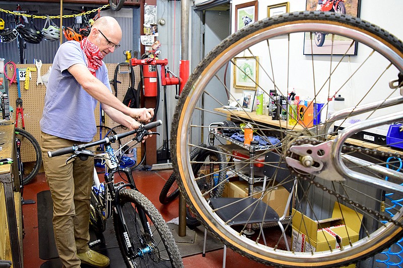 Staff Photo by Robin Rudd / Mike Skiles, owner of Suck Creek Cycle, overhauls a bycycle in his North Chattanooga Shop in May 2020. Cycling is seeing a boom during the COVID-19 pandemic.