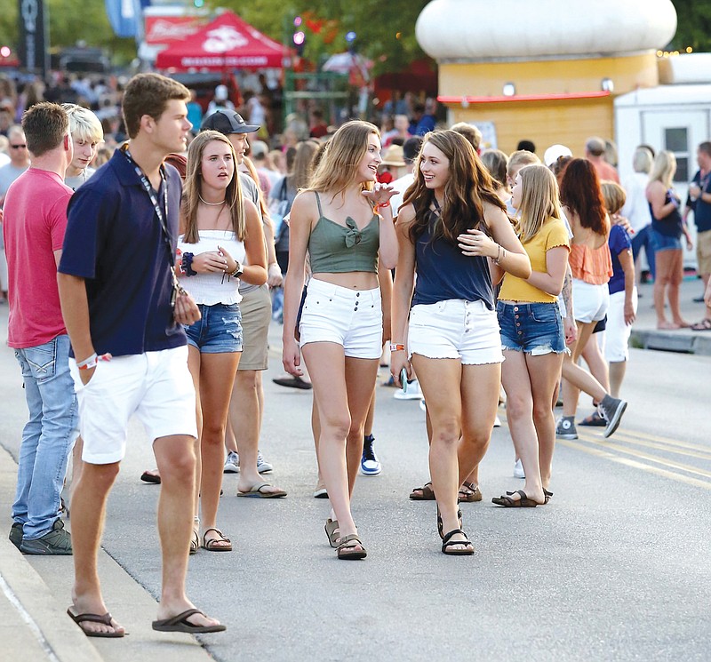 Festival-goers walk down Riverfront Parkway during the Riverbend Festival in 2019. / Staff File Photo