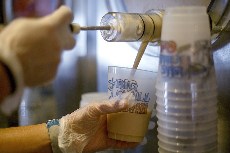 Staff photo by C.B. Schmelter / Donna Fochler pours a Bushwacker at The Big Chill and Grill on Tuesday, June 2, 2020 in Chattanooga, Tenn.