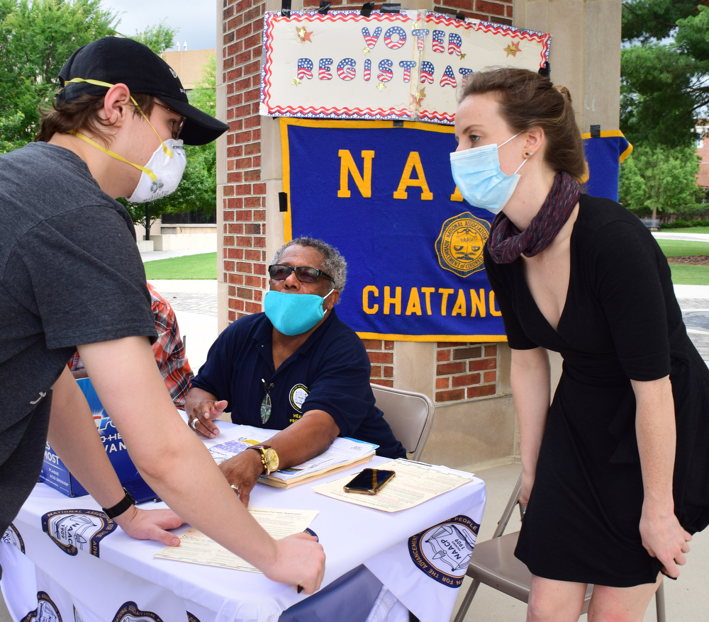 Staff Photo by Robin Rudd / From left, Colin Mathews gets registered to vote from NAACP member Dwight Smith and volunteer Meg Gorman.  UTC students and the Chattanooga community held a demonstration at the school's Chamberlain Field to show solidarity with Black Lives Matter.