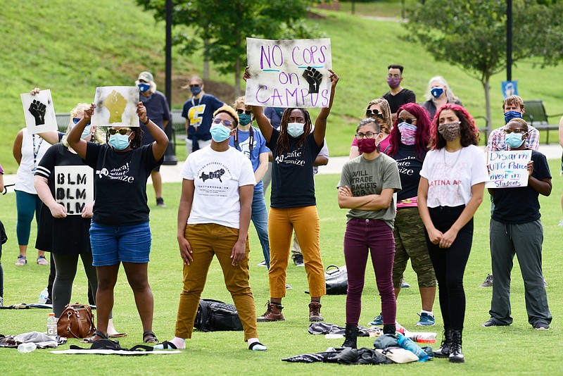 Staff Photo by Robin Rudd / People listen and hold signs during the rally. Most of the signs expressed a demand to defund the university police. UTC students and the Chattanooga community held a demonstration at the school's Chamberlain Field to show solidarity with Black Lives Matter.