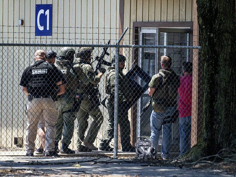 Law enforcement enter the C1 building to the west of the Bunn-O-Matic warehouse during an active shooter situation, Friday, June 26, 2020, in Springfield, Ill. Police say officers are searching for a gunman at a warehouse in the Illinois state capital after at least one person was shot and wounded. (Justin L. Fowler/The State Journal-Register via AP)


