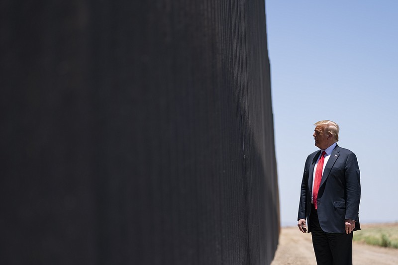 FILE - In this June 23, 2020, file photo, President Donald Trump tours a section of the border wall in San Luis, Ariz. A federal appeals court has ruled against the Trump administration in its transfer of military money to build sections of the U.S. border wall with Mexico. (AP Photo/Evan Vucci, File)


