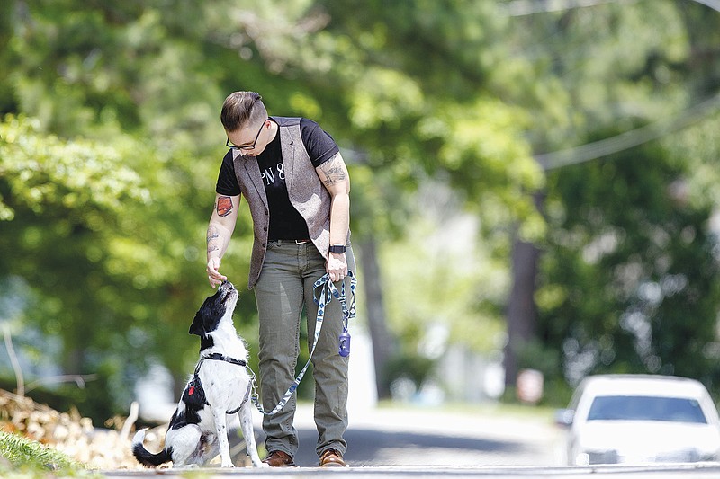 Staff photo by C.B. Schmelter / Shannon Millsaps walks her dog Sully.
