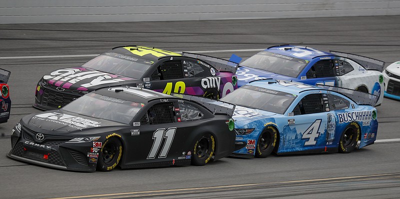 AP photo by John Bazemore / Denny Hamlin (11) takes the inside lane in front of Kevin Harvick (4) as Jimmie Johnson (48) keeps up during the NASCAR Cup Series race Monday at Talladega Superspeedway in Alabama.