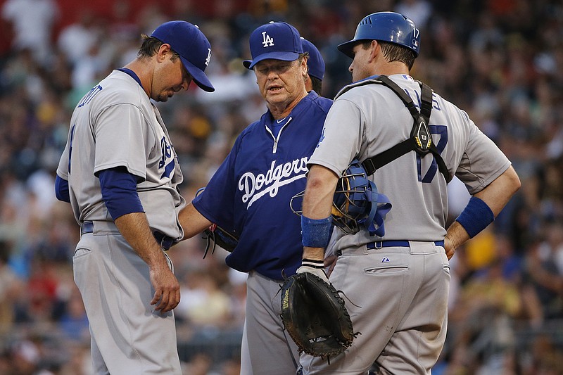 AP photo / Los Angeles Dodgers pitching coach Rick Honeycutt, center, talks with starter Josh Beckett and catcher A.J. Ellis during a game at Pittsburgh on July 22, 2014.