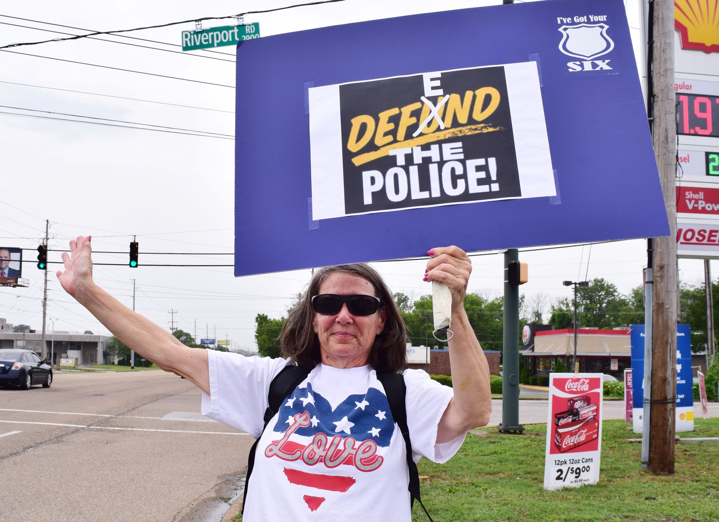 Staff Photo by Robin Rudd / Janice Williams waves at passing motorist during a rally to support the police. People gathered, June 27, 2020, along Amnicola Highway, in front of the Chattanooga Police Services Building, to rally in support of area police.
