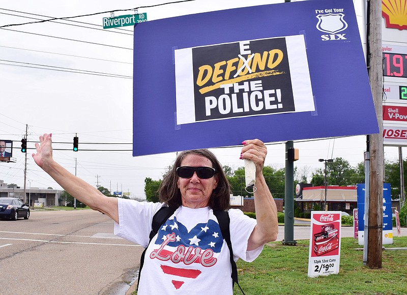 Staff Photo by Robin Rudd / Janice Williams waves at passing motorist during a rally to support the police.  People gathered, June 27, 2020, along Amnicola Highway, in front of the Chattanooga Police Services Building, to rally in support of area police.  