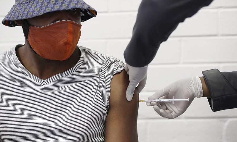 FILE - In this Wednesday, June 24, 2020 file photo, a volunteer receives a COVID-19 test vaccine injection developed at the University of Oxford in Britain, at the Chris Hani Baragwanath hospital in Soweto, Johannesburg, South Africa. People on six continents are testing experimental shots as the race for a COVID-19 vaccine enters a defining summer, with even bigger studies poised to prove if any leading candidate really works - and possibly offer the public a reality check. (AP Photo/Siphiwe Sibeko)