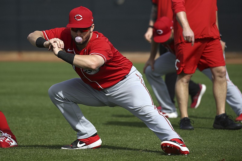 AP photo by Ross D. Franklin / Cincinnati Reds catcher Chris Okey blows a bubble as he stretches during a spring training workout on Feb. 21 in Goodyear, Ariz.