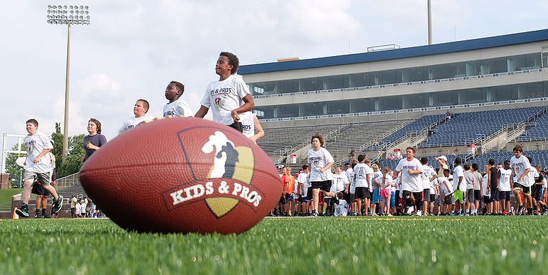 Staff photo / Youth football players take part in the Kids and Pros camp on July 13, 2015, at Finley Stadium.