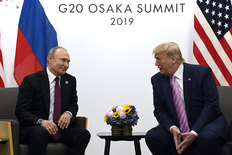 AP file photo, Susan Walsh / In this June 28, 2019, file photo, President Donald Trump, right, meets with Russian President Vladimir Putin during a bilateral meeting on the sidelines of the G-20 summit in Osaka, Japan. Trump now denies being bried by U.S. Intelligence officials about Russian bounties on the heads of U.S. soldiers in Afghanistan.