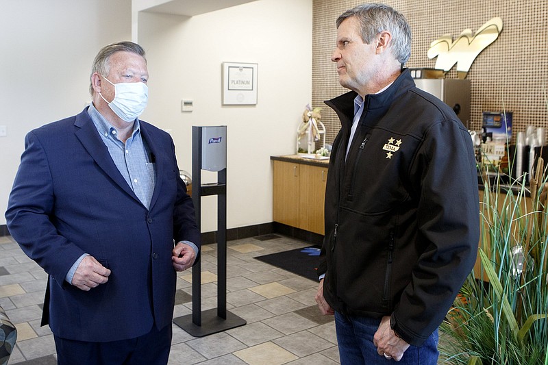 Staff photo by C.B. Schmelter / Gov. Bill Lee, right, and Hamilton County Mayor Jim Coppinger talk after a press conference at Wilson Air Center on Tuesday, April 14, 2020 in Chattanooga, Tenn.