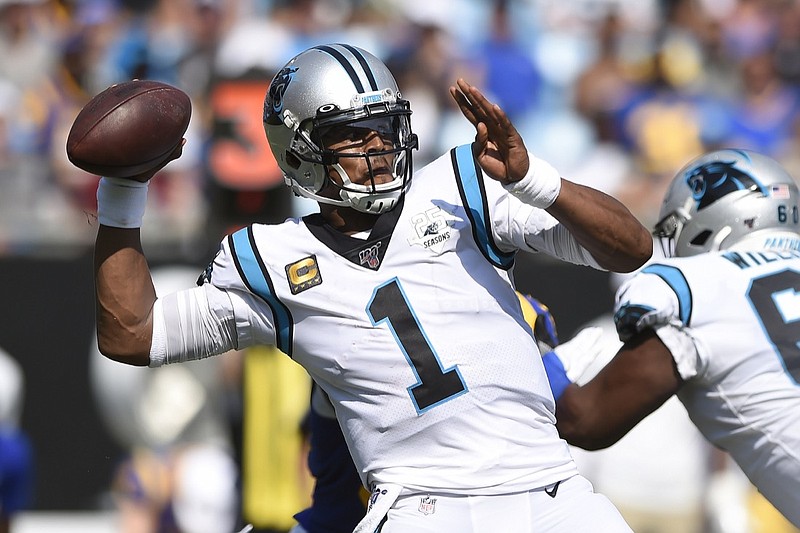 FILE - In this Sept. 9, 2019, file photo, Carolina Panthers quarterback Cam Newton looks for a receiver during the team's NFL football game against the Los Angeles Rams during the second half in Charlotte, N.C. The New England Patriots have reached an agreement with free-agent quarterback Newton, bringing in the 2015 NFL Most Valuable Player to help the team move on from three-time MVP Tom Brady, a person with knowledge of the deal told The Associated Press. (AP Photo/Mike McCarn, File)