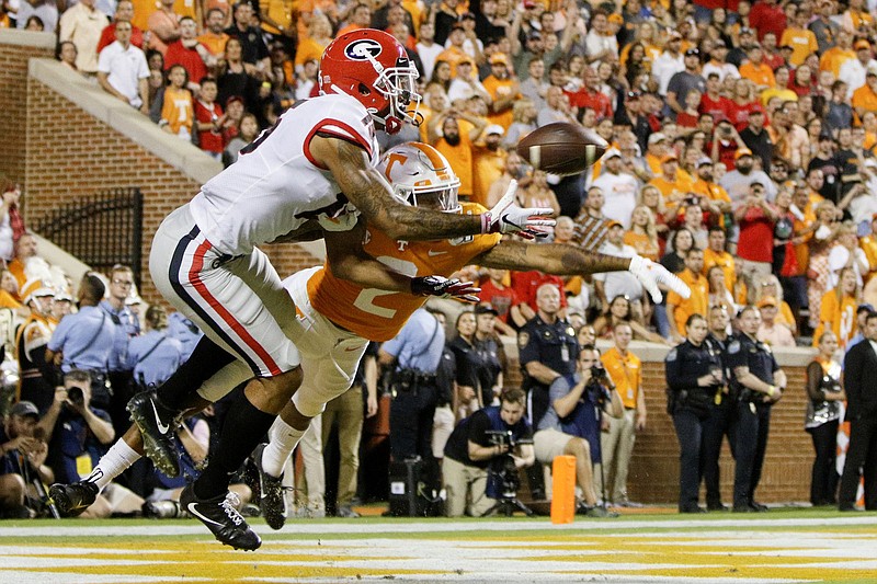 Staff photo by C.B. Schmelter / Cody Schmelter's photo of Georgia wide receiver Lawrence Cager catching a 3-yard touchdown against Tennessee defensive back Alontae Taylor won first place in sports in the Green Eyeshade contest.