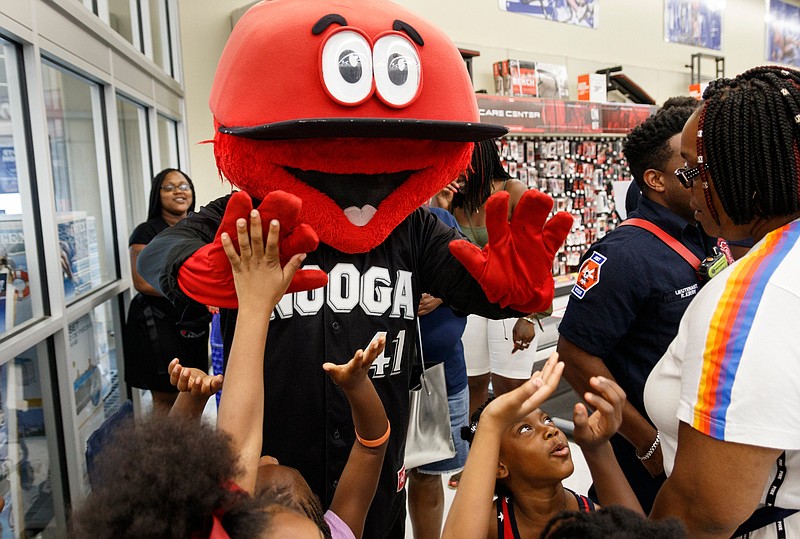 Children from the YMCA Westside and Salvation Army high-five Looie the Lookout before a shopping spree at Academy Sports and Outdoors on Thursday, July 18, 2019, in Chattanooga, Tenn. Academy partnered with the Chattanooga Lookouts to give the children each a $100 gift card for back-to-school shopping.