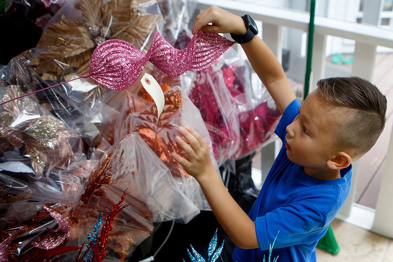 Staff photo by C.B. Schmelter / Five-year-old Ryan Dehoney demonstrates to the Times Free Press how he puts together floral arrangements at his home on Tuesday, June 30, 2020 in Signal Mountain, Tenn. Dehoney is an entrepreneur who helped start College Bound, a local company that makes floral arrangements, to help save for college and help others.