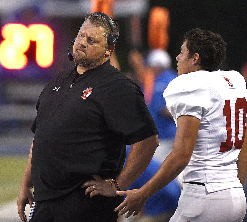 Staff photo by Robin Rudd / Lakeview-Fort Oglethorpe football coach Bo Campbell listens to Warriors player Carson McCammon during a game at Ringgold on Sept. 20, 2019.  