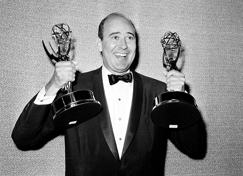 FILE - In this May 26, 1963 file photo, Carl Reiner shows holds two Emmy statuettes presented to him as best comedy writer for the "Dick Van Dyke Show," during the annual Emmy Awards presentation in Los Angeles. Reiner, the ingenious and versatile writer, actor and director who broke through as a "second banana" to Sid Caesar and rose to comedy's front ranks as creator of "The Dick Van Dyke Show" and straight man to Mel Brooks' "2000 Year Old Man," has died, according to reports. Variety reported he died of natural causes on Monday night, June 29, 2020, at his home in Beverly Hills, Calif. He was 98. (AP Photo, File)