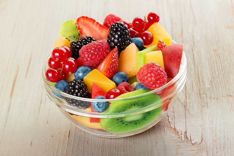 bowl of fruit salad isolated on wood table - stock photo food tile fruit tile / Getty Images
