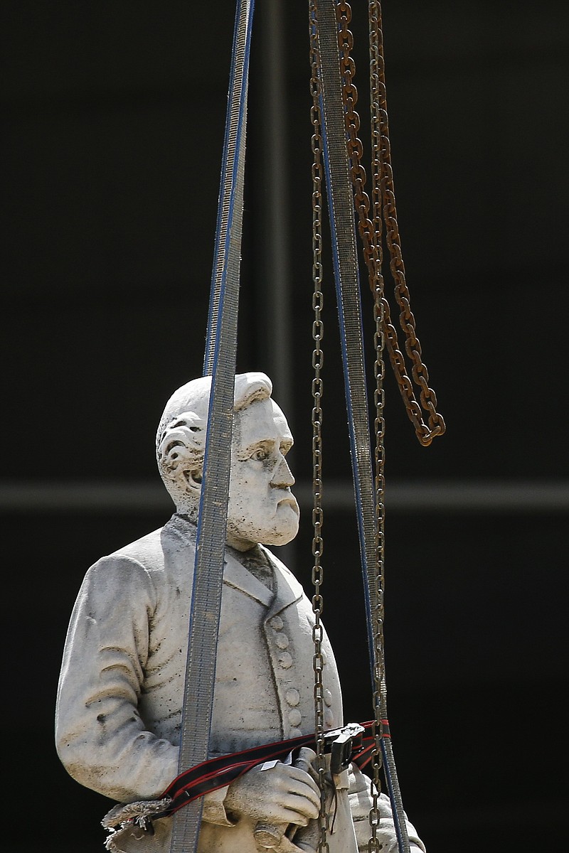 Photo by Ryan Michalesko of The Dallas Morning News / Construction workers move a statue of Gen. Robert E. Lee as they begin the removal of The Confederate War Memorial at Pioneer Park on Wednesday, June 17, 2020 in downtown Dallas.