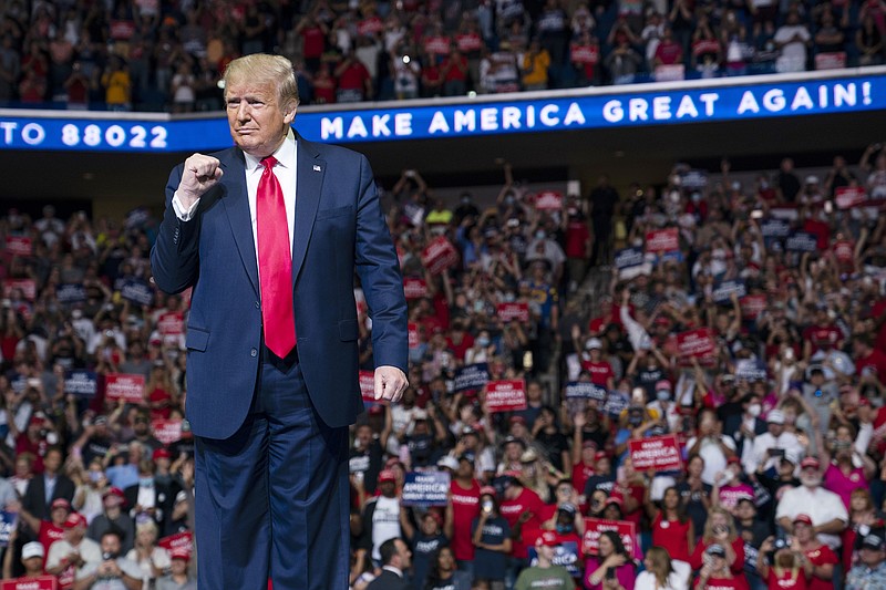 Photo by Evan Vucci of The Associated Press / President Donald Trump arrives on stage to speak at a campaign rally at the BOK Center on Saturday, June 20, 2020, in Tulsa, Oklahoma. Trump is asking Americans to let him keep his job. His critics are asking how much of that job he's actually doing.