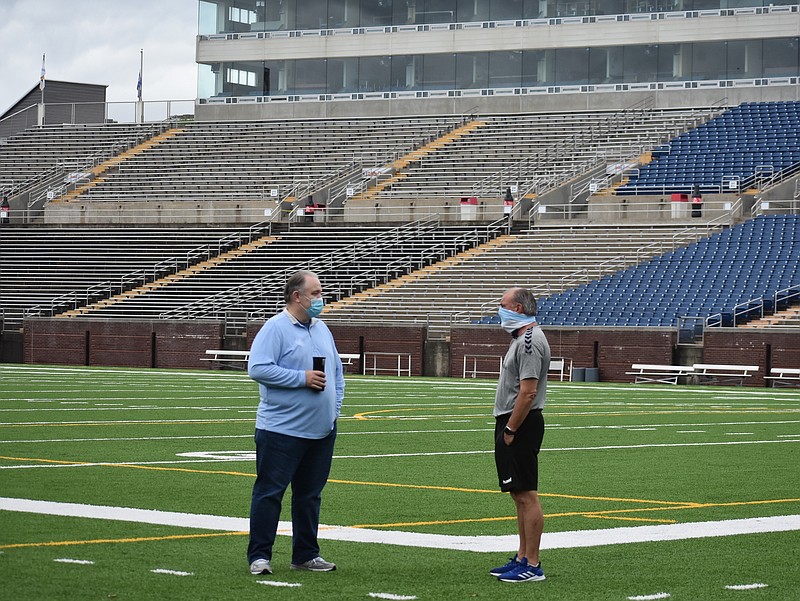 Staff photo by Patrick MacCoon / Chattanooga Football Club's chief marketing officer Owen Seaton, left, and head coach Peter Fuller talk after Wednesday's practice at Finley Stadium. CFC will play in the NISA Independent Cup on July 11 and 18 at home, but both matches will be closed to the public.