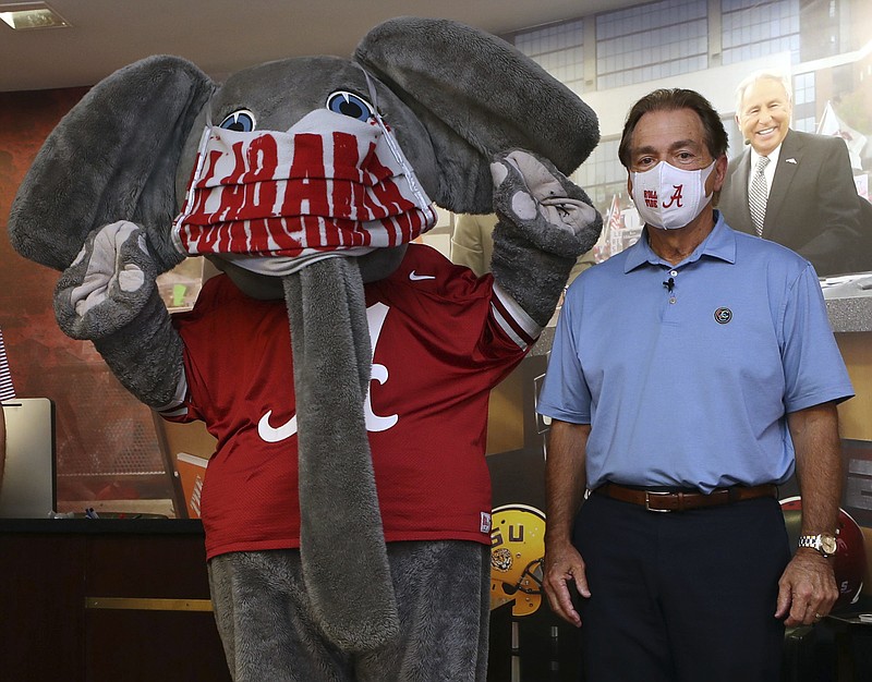 Alabama photo by Kent Gidley / Alabama football coach Nick Saban poses with the Crimson Tide's elephant mascot, Big Al, on May 20 on campus in Tuscaloosa, with both wearing face masks to help prevent the spread of COVID-19.