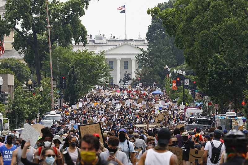 FILE - In this Saturday, June 6, 2020 file photo, demonstrators gather near the White House in Washington, to protest the death of George Floyd, a black man who was in police custody in Minneapolis. Public health experts say there is little evidence that the protests that erupted after Floyd's death caused a significant increase in coronavirus infections. If the protests had driven an explosion in cases, experts say, the jumps would have started to become apparent within two weeks — and perhaps as early as five days. (AP Photo/Jacquelyn Martin)