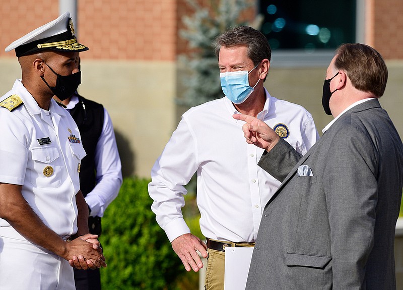 Staff Photo by Robin Rudd / From left,  Surgeon General Jerome Adams, Gov. Brian Kemp and state senator Jeff Mullis talk  before the press conference.  Gov. Brian Kemp was in Dalton Thursday morning, along with U.S. Surgeon General Jerome Adams as part of his statewide "Wear a Mask" tour. He's going around to different COVID hot spots and urging people to wear masks. 