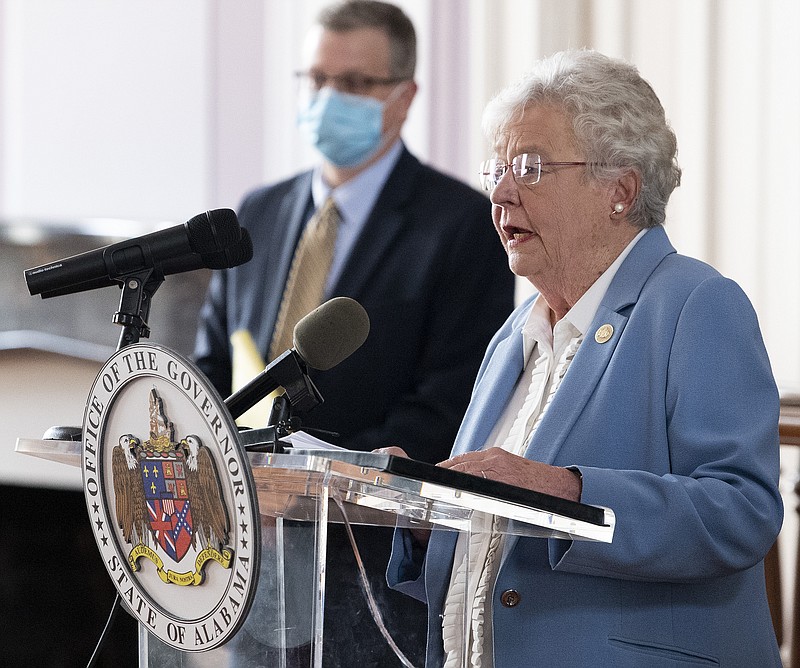 Governor Kay Ivey and State Health Officer Dr. Scott Harris ask citizens to continue wearing masks and use social distancing during a coronavirus update in the state capitol building in Montgomery, Ala., on Tuesday June 29, 2020. (Mickey Welsh/The Montgomery Advertiser via AP)


