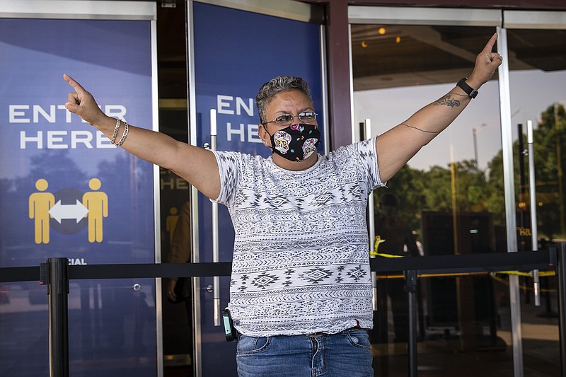 A Mount Prospect woman who identified herself as "Sunshine" celebrates as she enters Rivers Casino in Des Plaines on the first day of reopening following an unprecedented three-month shutdown due to the coronavirus pandemic, Wednesday, July 1, 2020. | (Ashlee Rezin Garcia/Chicago Sun-Times via AP)


