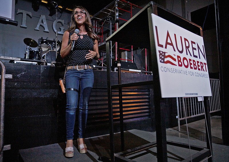 FILE - Businesswoman Lauren Boebert speaks during a watch party at Warehouse 25 Sixty Five in Grand Junction, Colo., after polls closed in Colorado's primary election on Tuesday, June 30, 2020. Boebert, a pistol-packing restaurant owner who has expressed support for a far-right conspiracy theory has upset five-term Colorado U.S. Rep. Scott Tipton. Lauren Boebert is an ardent defender of gun rights and border wall supporter. She will run in November's general election against Diane Mitsch Bush, who won the Democratic nomination on Tuesday. (McKenzie Lange/Grand Junction Sentinel via AP, File)