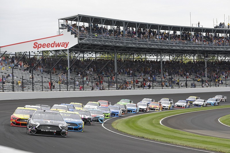AP photo by Darron Cummings / NASCAR driver Kevin Harvick leads the field through the first turn at Indianapolis Motor Speedway during a Cup Series race on  Sept. 8, 2019.
