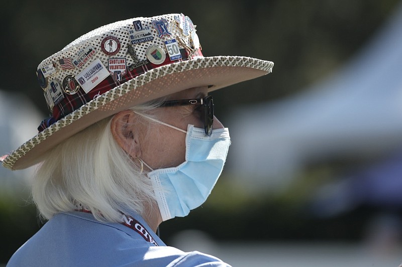 Cheryl Pearce, a volunteer working the first tee, wears a mask as a precaution against the coronavirus, at the start the third round of the RBC Heritage golf tournament, Saturday, June 20, 2020, in Hilton Head Island, S.C. (AP Photo/Gerry Broome) Cheryl Bearce


