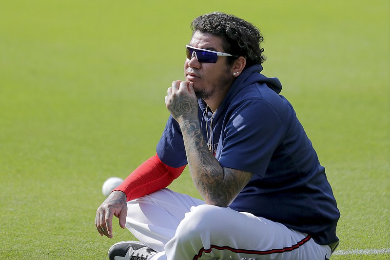 AP photo by Brynn Anderson / Félix Hernandez sits on the grass at Truist Park during the Atlanta Braves' workout on Friday. Hernandez told the team Sunday that he has decided not to play this season due to the coronavirus pandemic.