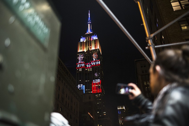 New York Times File Photo / Spectators view a projection of the Electoral College tallies on the Empire State Building in New York City on election night in 2016.