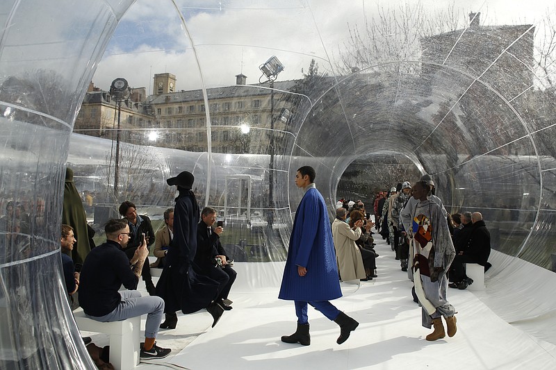 In this Feb. 26, 2020 file photo, models wear creations for the Kenzo fashion collection during Women's fashion week Fall/Winter 2020/21 presented in Paris. The coronavirus pandemic has instilled extra unpredictability into the already fickle Paris Fashion Week. After first canceling the July shows for menswear and Haute Couture, the French fashion federation has now organized an unprecedented schedule of digital-only events instead. (AP Photo/Thibault Camus, File)