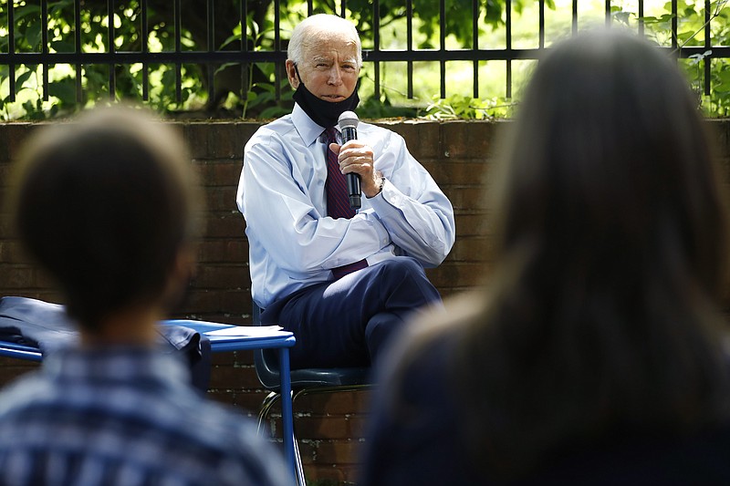 FILE - In this June 25, 2020, file photo, Democratic presidential candidate former Vice President Joe Biden, center, speaks to Stacie Ritter, right, and her son, Jan, during a meeting with families who have benefited from the Affordable Care Act in Lancaster, Pa. Biden is hoping to capture Florida and other pivotal states by pushing Latino turnout rates higher than when Hillary Clinton lost to Donald Trump in 2016. (AP Photo/Matt Slocum, File)


