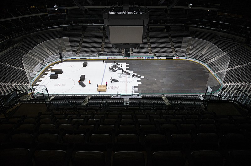 AP photo by Ashley Landis / Crews cover the ice at American Airlines Center on March 12 in Dallas, home of the NHL's Stars, after the league suspended its 2019-20 season due to the coronavirus pandemic.