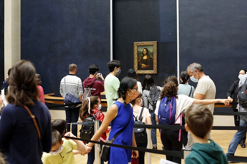 Visitors wait to see the Leonardo da Vinci's painting Mona Lisa, in Paris, Monday, July 6, 2020. The home of the world's most famous portrait, the Louvre Museum in Paris, reopened Monday after a four-month coronavirus lockdown. (AP Photo/ Thibault Camus)


